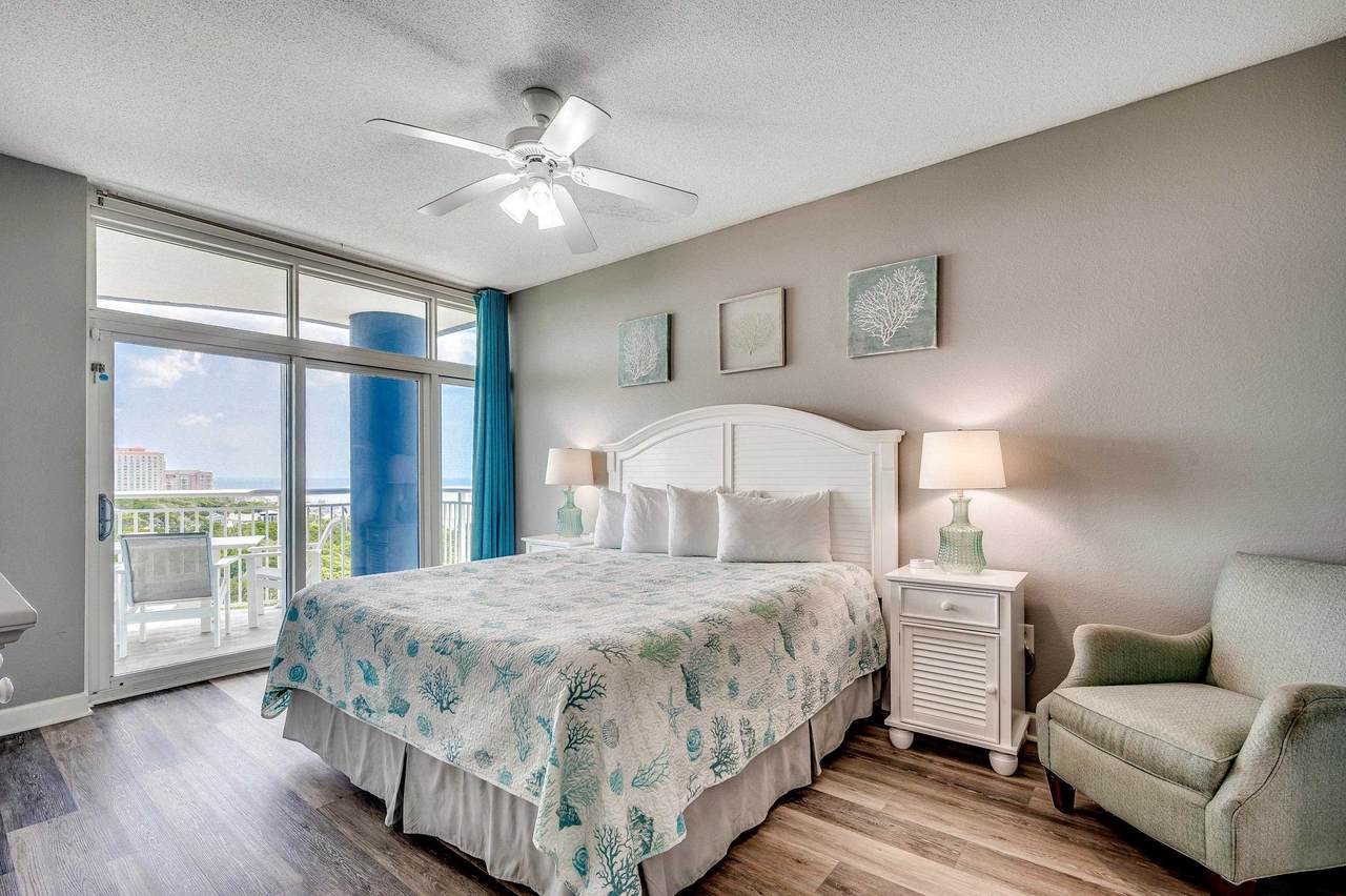 Furnished primary bedroom with balcony access
