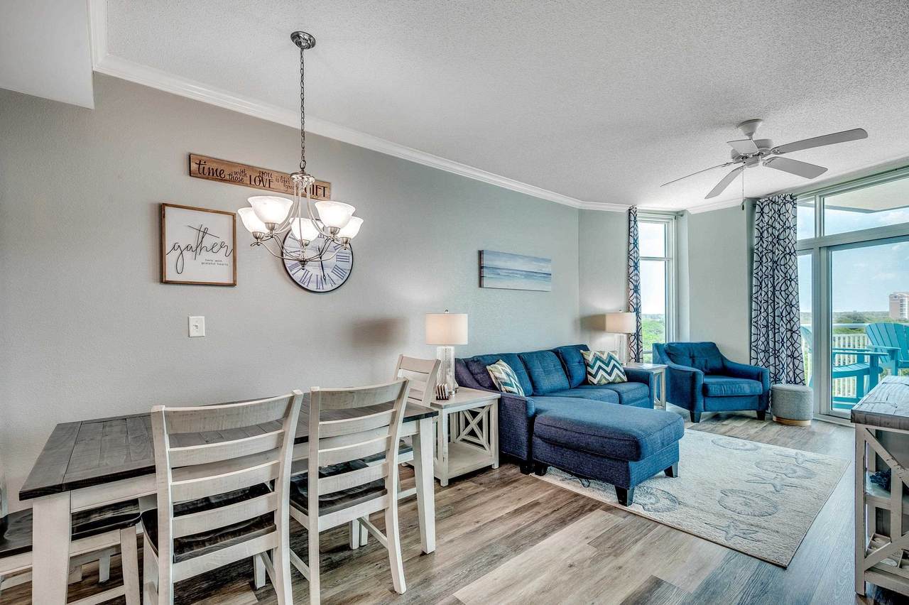 Open furnished dining and living area with balcony doors