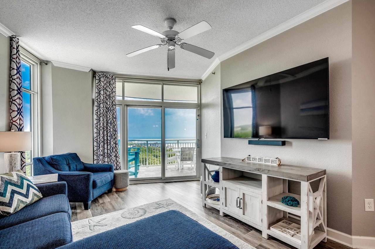 Furnished living room with television and ocean-view windows