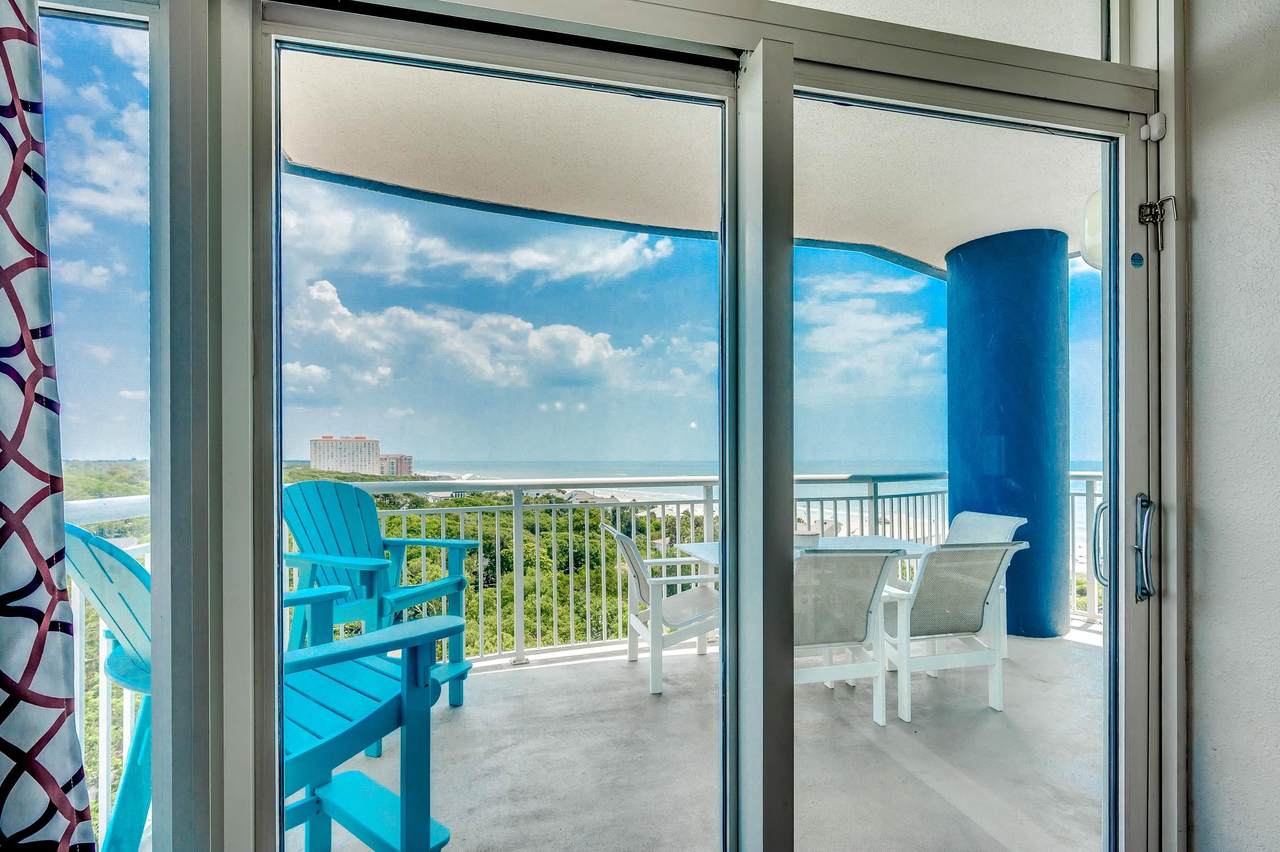 Private balcony with seating and a view toward the ocean