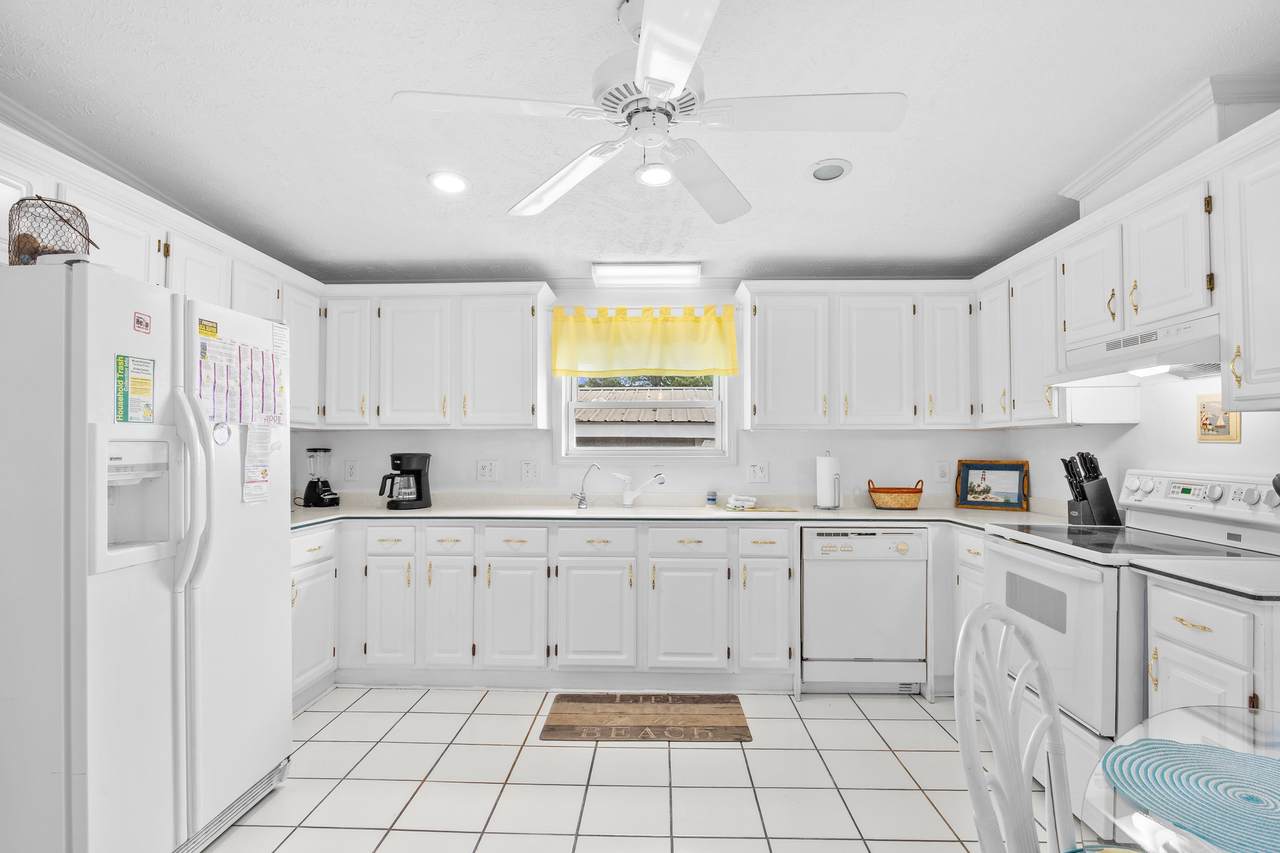 Kitchen work area with white appliances and a breakfast nook