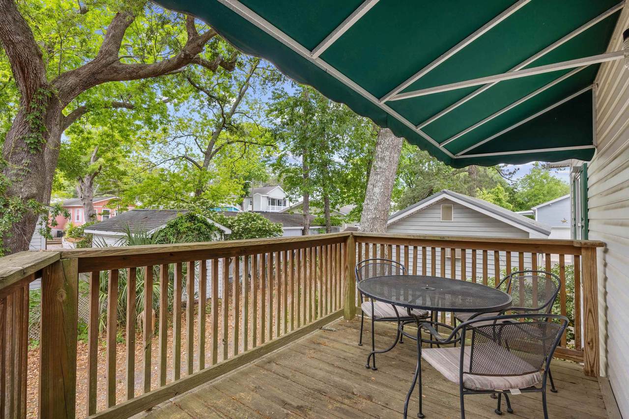 Shaded front porch with green retractable awning