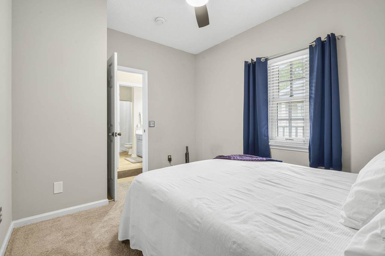 Bathroom with blue vanity and tub-shower combination