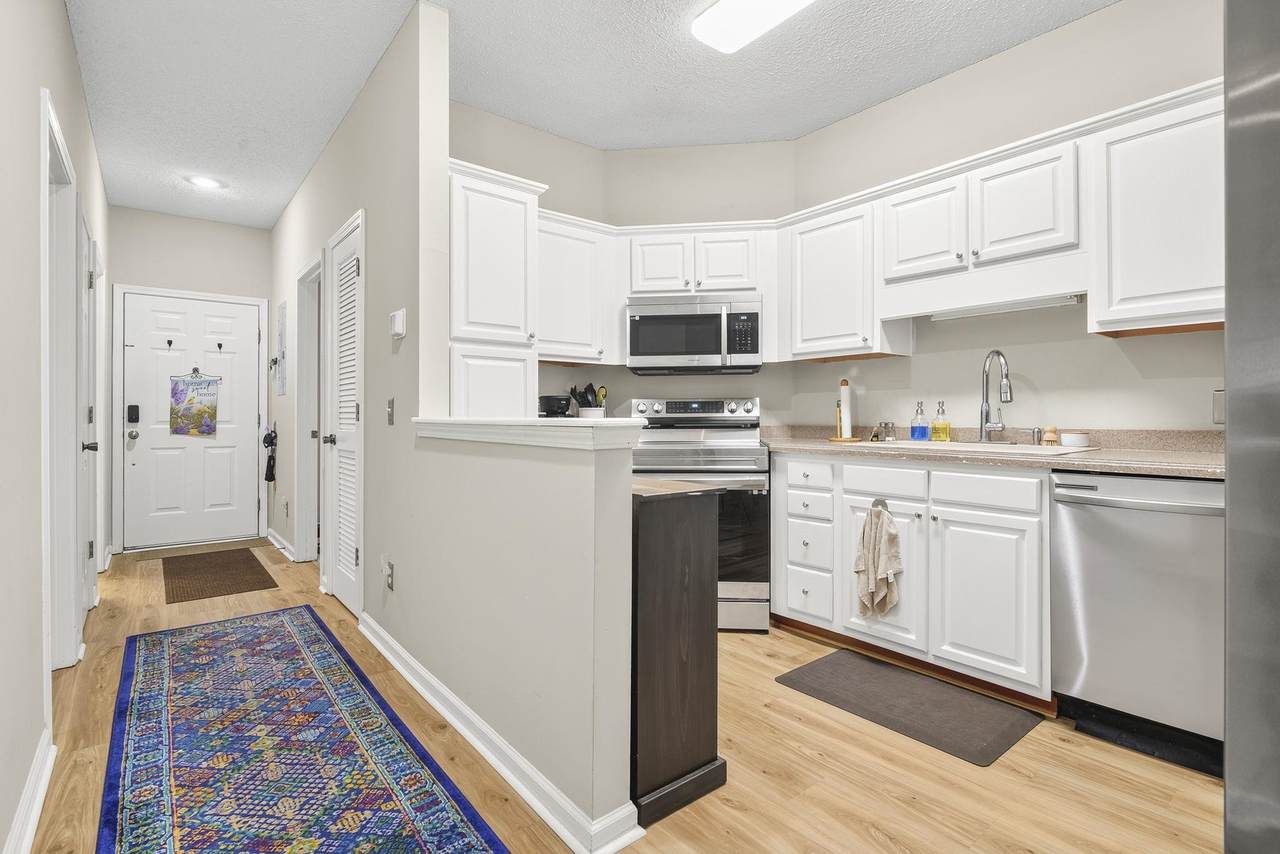 White kitchen and hallway inside 6210 Sweetwater Boulevard