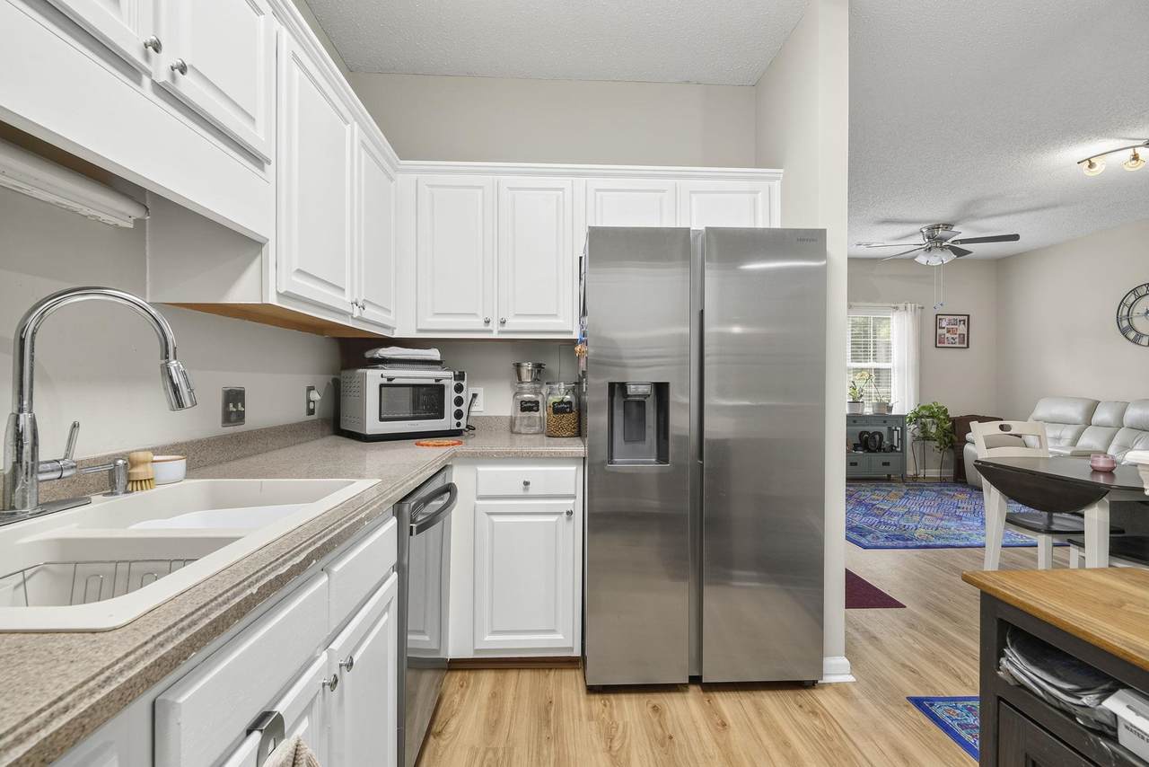 Kitchen with white cabinets and stainless-steel refrigerator