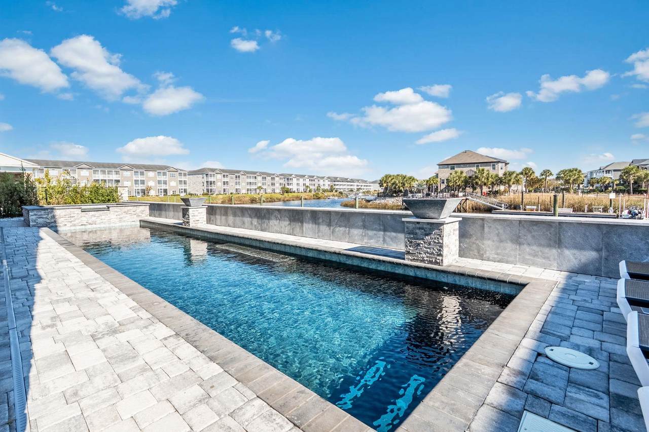 Private waterfront pool and spa behind the home