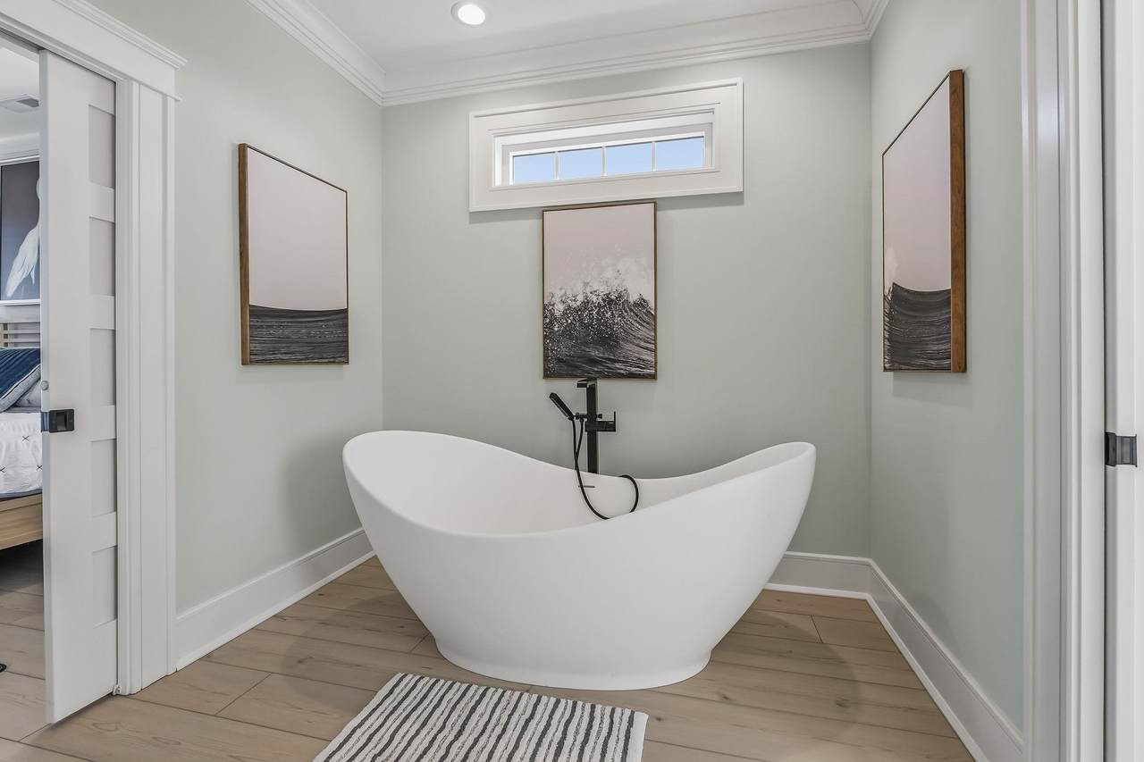 Tiled walk-in shower beside the freestanding tub