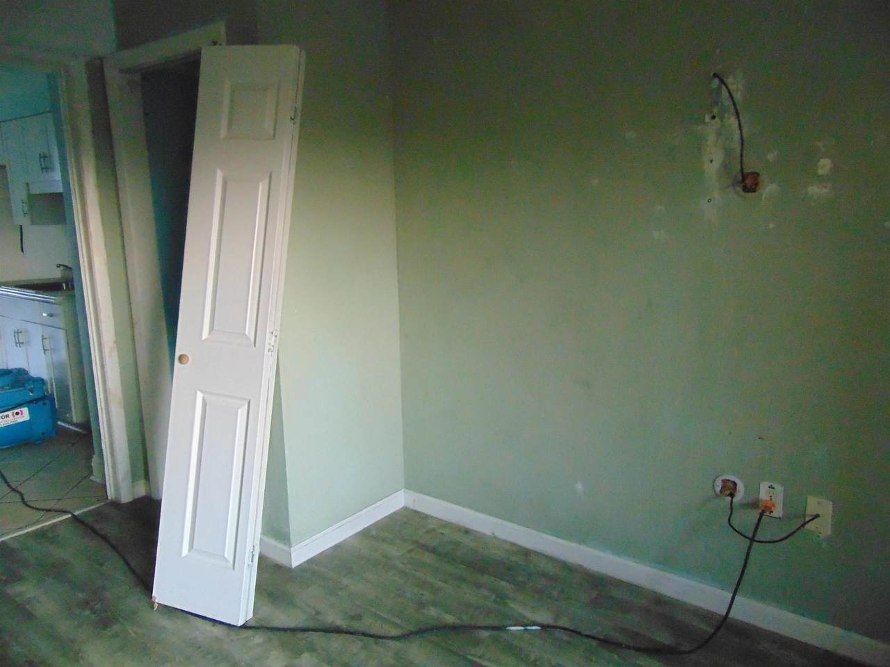 Interior utility area with exposed plumbing connections