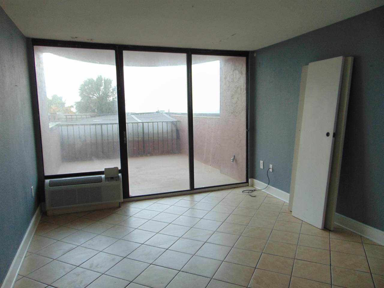 Tiled oceanfront room opening to the private balcony