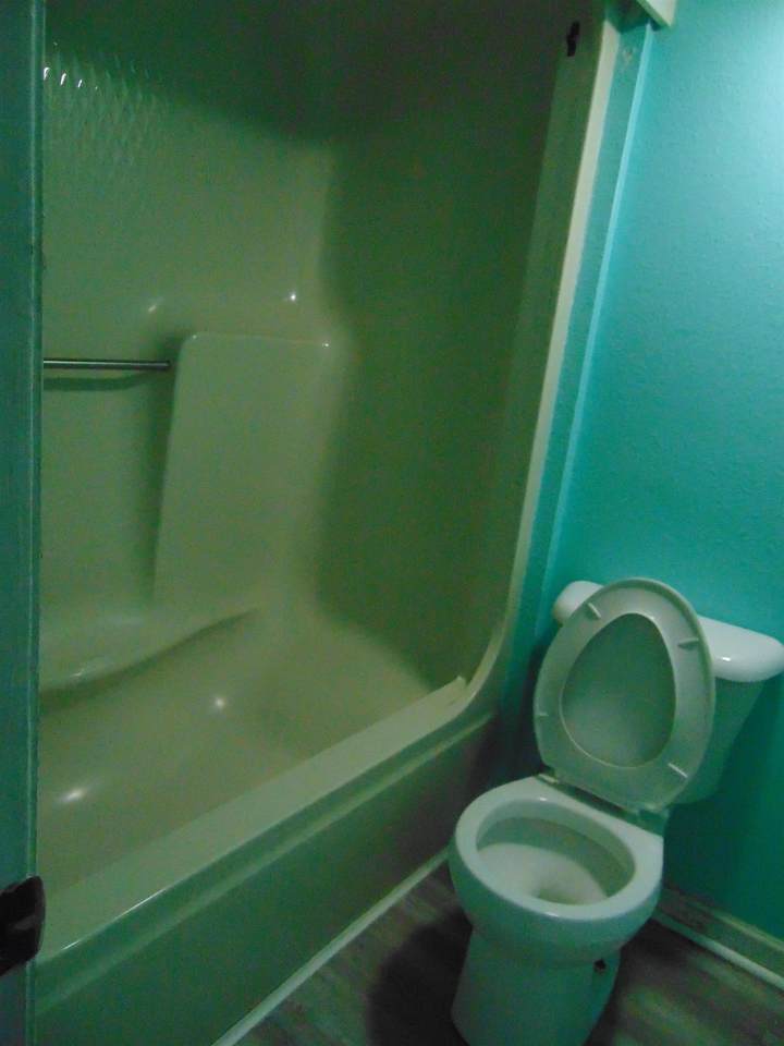 Bathroom area with tub and shower and no vanity