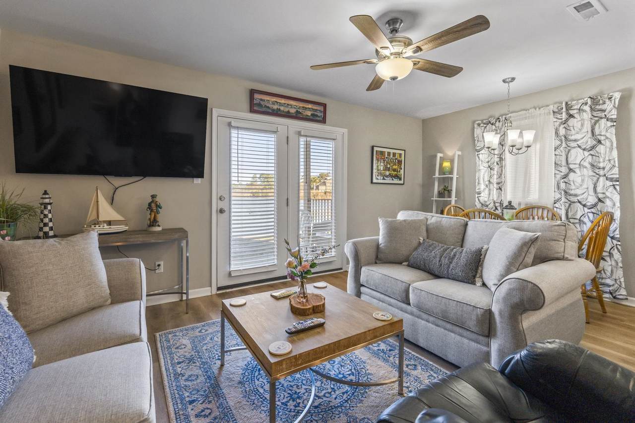 Living room with pond-facing glass doors and neutral furnishings