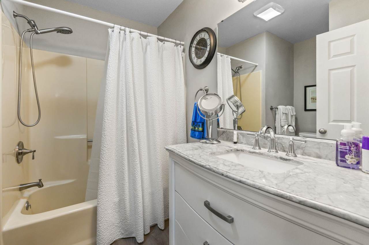 Bathroom with tub and shower combination and vanity