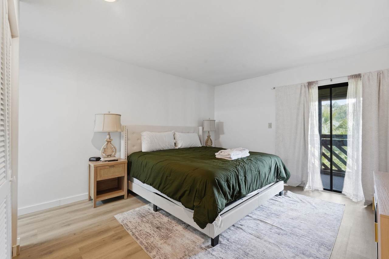 Main-level bedroom with sliding doors to the screened porch