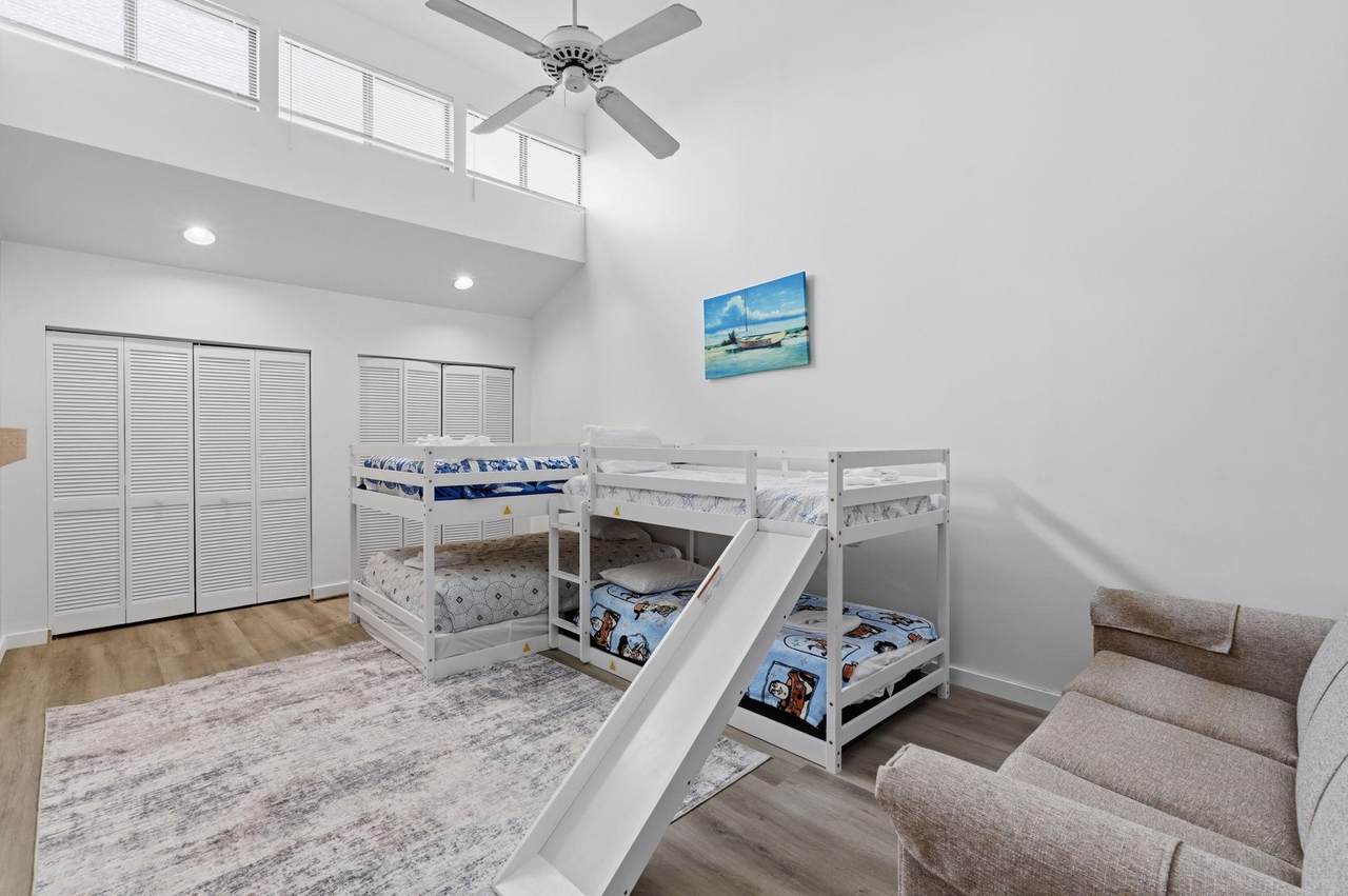 Loft bedroom beneath a vaulted ceiling