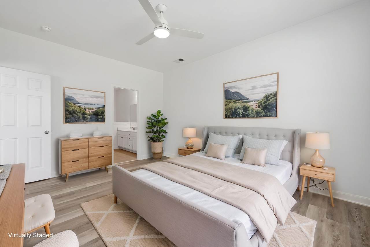Primary bedroom with ceiling fan and natural light