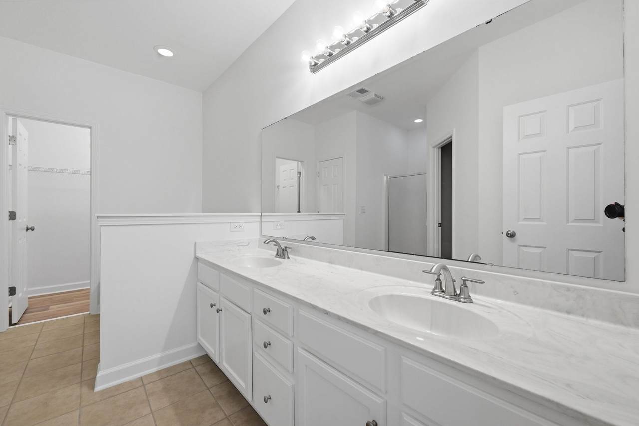 Primary bathroom with double vanity, garden tub and separate shower