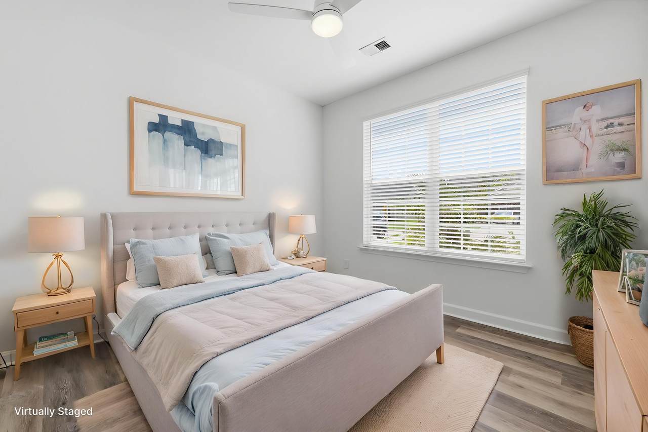 Secondary bedroom with light flooring and ceiling fan