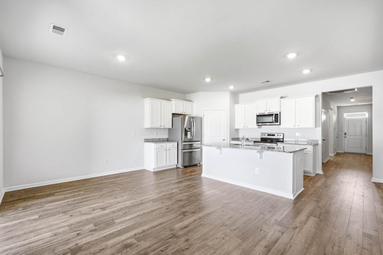 Open kitchen and living area with recessed lighting