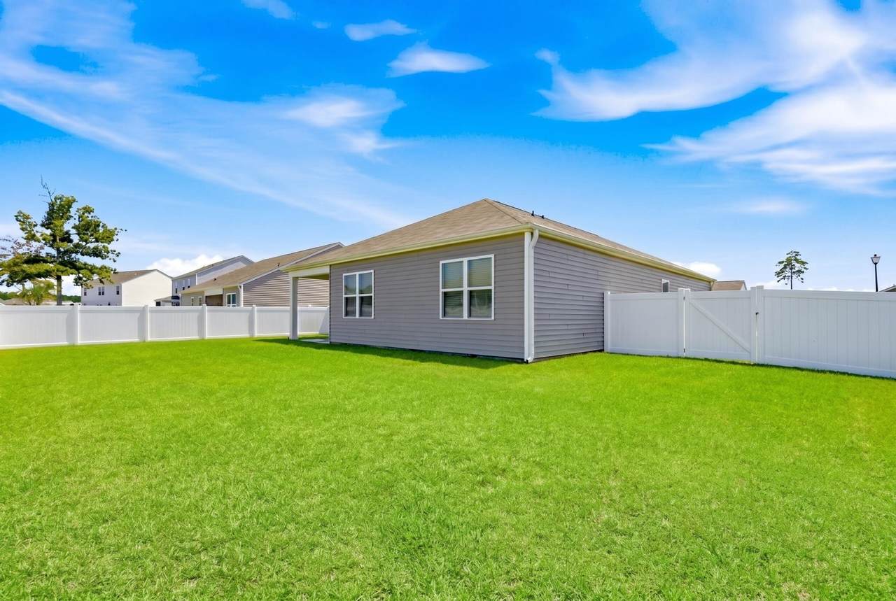 Fenced backyard behind the single-story home