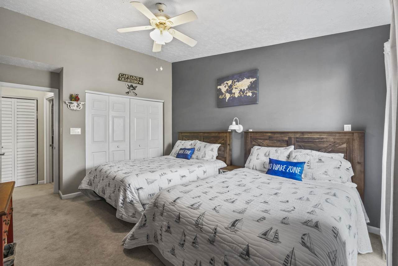 Bedroom with ceiling fan and coastal decor